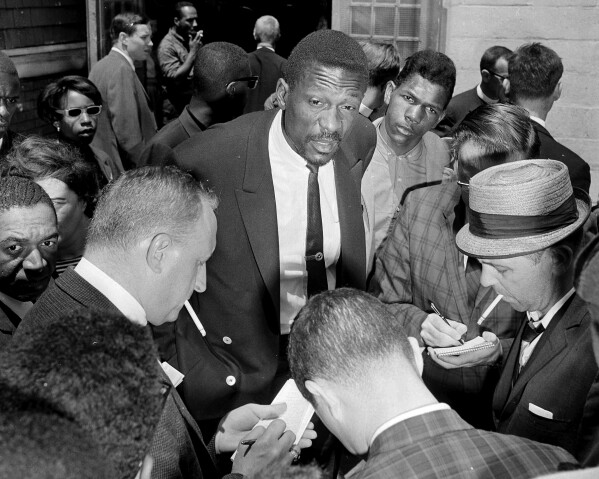 Boston Celtics star Bill Russell talks with reporters about the boycott of Boston public schools by African Americans, in Boston, on June 18, 1963. Russell spoke to some of the estimated 3,000 children who stayed away from regular classes but attended special sessions called by Black leaders. Children were asked by their parents to stay away from regular classes in protest against what they said was actual if not legal segregation. (AP Photo/Frank Curtin, File)