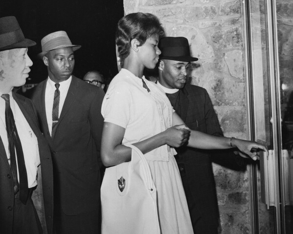 Olympic sprint star Wilma Rudolph tries unsuccessfully to be served at a restaurant in her hometown of Clarksville, Tenn., along with 300 others, on May 30, 1963. With her are, from left: Dr. F.D. Coleman, Dr. Paul Dumas and the Rev. Carl Liggin, chairman of the local Christian Leadership Council. (AP Photo/File)